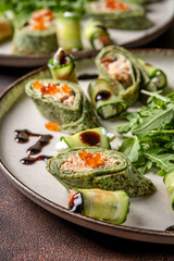 Spinach crepe rolls with salmon and caviar