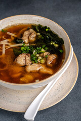 Asian pork noodle soup in ceramic bowl