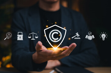 Copyright protection concept. Person holding copyright icon with legal, security, and intellectual...