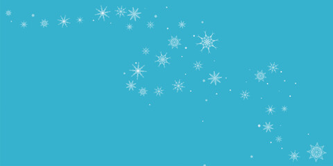 White delicate, lacy snowflakes are carried by the wind against a blue background. 