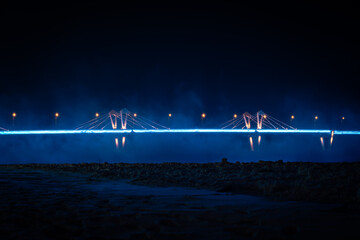 Night view of an illuminated bridge crossing the Zeya River in Blagoveshchensk, Russia