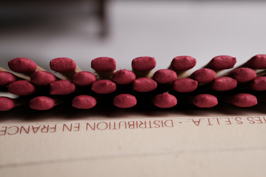 A Detailed, Shallow Depth-of-Field Macro Shot of Uniformly Arranged, Deep Crimson Match