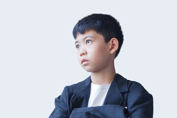 A young boy in a black suit, with a determined and ambitious expression, sets his sights on becoming a future businessman.
