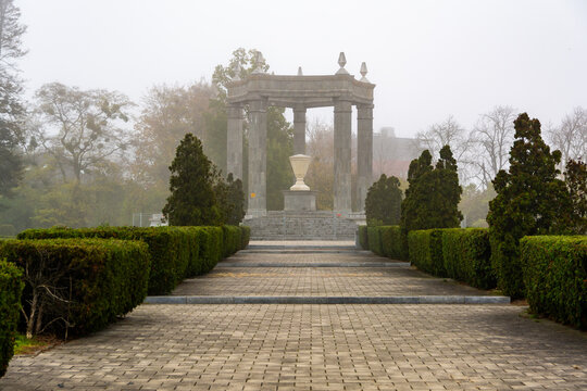 Foggy Park Walkway Leading To Stone Monument, Symmetry And Garden Architecture