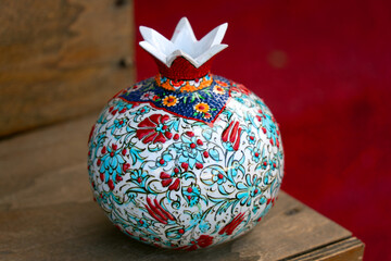 A beautifully crafted ceramic pot resembling a pomegranate, showcasing intricate details and...