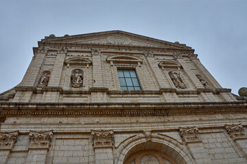 Obraz premium Low-angle view of the monumental stone facade of the Church of Santa Cruz in Medina de Rioseco, Valladolid.