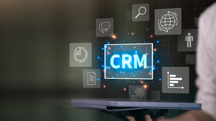 CRM glowing on a digital interface surrounded by icons like charts, chat, documents, gears, and analytics, representing data management, automation, and customer engagement in business systems.