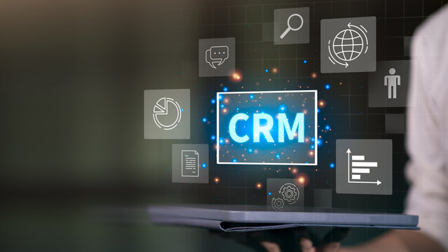 CRM glowing on a digital interface surrounded by icons like charts, chat, documents, gears, and analytics, representing data management, automation, and customer engagement in business systems. - Powered by Adobe