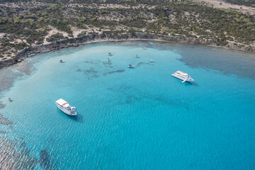 Obraz premium Drone aerial of Blue lagoon akamas cyprus with luxury boats sailing