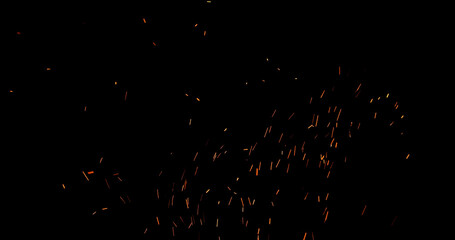 Realistic fire sparks flying through the air, isolated on a black background. Perfect as a cinematic VFX overlay, fire particles effect or visual element.