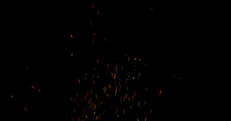 Realistic fire sparks flying through the air, isolated on a black background. Perfect as a cinematic VFX overlay, fire particles effect or visual element.