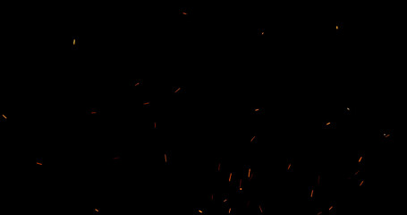 Realistic fire sparks flying through the air, isolated on a black background. Perfect as a...