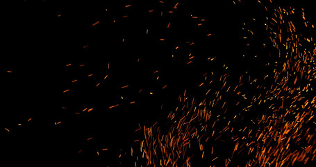 Realistic fire sparks flying through the air, isolated on a black background. Perfect as a cinematic VFX overlay, fire particles effect or visual element.