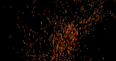 Realistic fire sparks flying through the air, isolated on a black background. Perfect as a cinematic VFX overlay, fire particles effect or visual element.