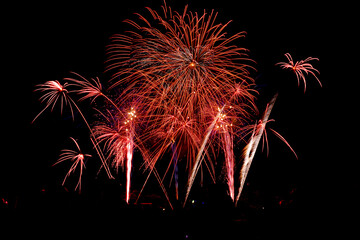 Colorful fireworks display exploding in dark night sky, festive celebration background with copy...