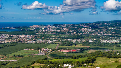 aerial view across green Martinique landscape with city of Fort-de-France next to Fort-de-France Bay, agricultural land and gently rising terrain, Lesser Antilles, Caribbean