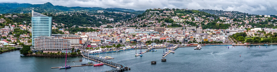 aerial view of central part of Fort-de-France, with Malecon, Cruise Shipp Terminal, Tour Lumina, and hilly landscape built-up in the background, situated in Martinique, Lesser Antilles, Caribbean