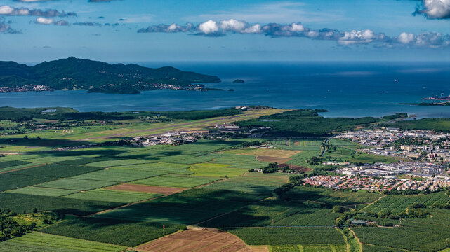 aerial view of green Martinique landscape with Martinique Aim&eacute; C&eacute;saire International Airport and Fort-de-France Bay in Background, situated on Martinique west coast Lesser Antilles, Caribbean