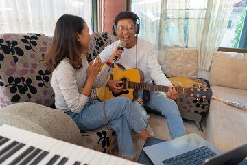 The couple is practicing playing a musical instrument.