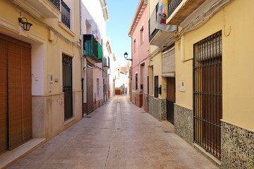A narrow street in old Spain or Mexico