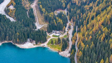 aerial landscape view of area around northeast part of turquoise Antholzer See, a lake in the Antholzertal in South Tyrol, Italy, with "Enzianh&uuml;tte" and "Platzl am See" restaurant