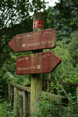 Wooden sign of natural trails of Spain. Hiking directional arrow signpost in Asturias, Northern Spain