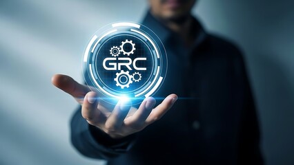 A man holding a glowing blue orb with grc logo and gears inside
