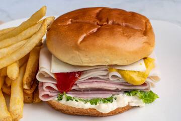turkey and ham sandwich served with french fries