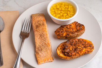 baked salmon with potato skins and corn