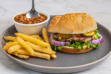 smashburger  with bake beans and a side of french fries