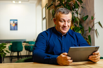 Man Reading Data on Tablet During Work Session