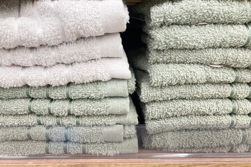 Towels in a stack on the shelves in the supermarket.