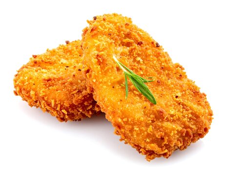 Two rectangular fried chicken cutlets with herb garnish against a clean, white background