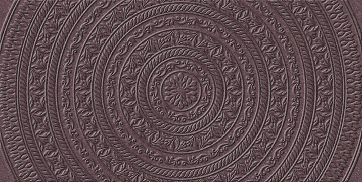 Round pattern embossed on imitation of thick brown-red cardboard. Mandala. 