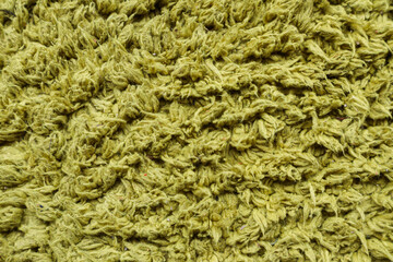 Green fabric texture background with rough woven fibers and detailed surface pattern, suitable for textile, material, abstract, and background design use.