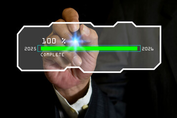 Businessman's hand interacting with a digital loading bar transitioning from 2025 to 2026 download complete.