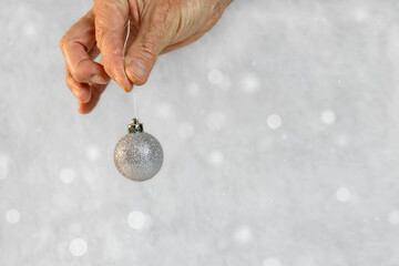 Beautiful silver Christmas ball on a gray background.