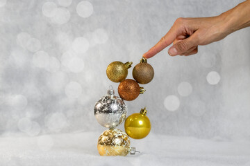 Girl holding Christmas balls in her hand.