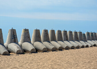 Coastal tetrapods form a barrier along the beach.