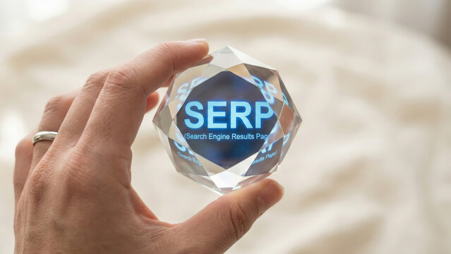 Holding crystal prism with SERP and Search Engine Results Page glowing, symbolizing digital marketing success and quest for visibility