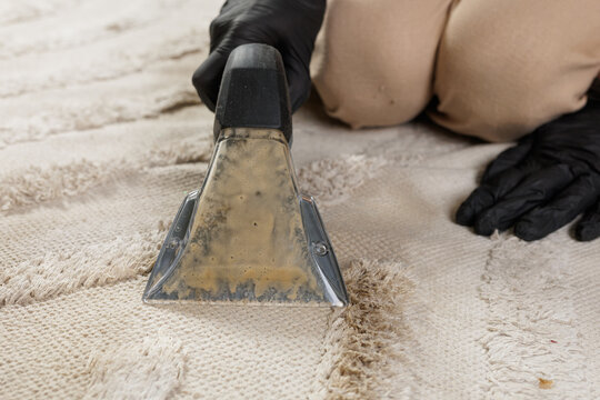 Dirty water in carpet extractor nozzle after deep rug cleaning