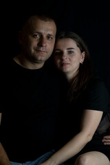 Couple expressing love and intimacy on black background