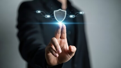 A sharply focused, professional businessperson in a dark suit is depicted interacting with a vibrant, futuristic digital security shield interface composed of glowing blue lines and nodes, extending