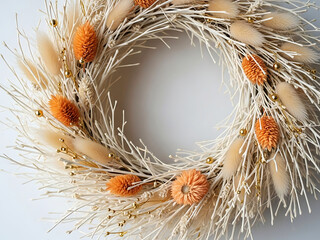 Rustic white branch wreath decorated with orange billy buttons and bunny tails