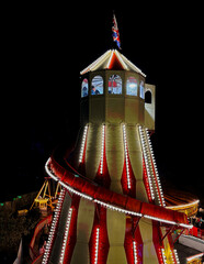 Illuminated Helter-Skelter in a fairgound.  Taken in low light and from elevated position