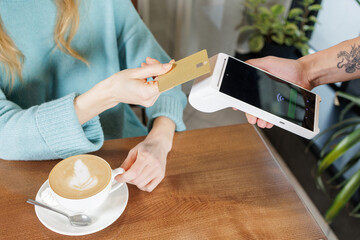 Tableside contactless NFC card payment with portable POS terminal in cafe