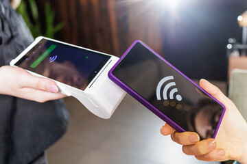 Tap to Pay Smartphone NFC Transaction on Handheld POS Terminal at Cafe Checkout