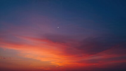 Fototapeta premium Vivid gradient sunset sky transitioning from warm orange to deep purple, perfect for backgrounds and design.