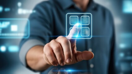 Illuminated futuristic application grid icon with a glowing blue outline and a minimalist wireframe design, is being digitally interacted with by a businessman&rsquo;s outstretched finger in a blurred,