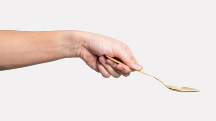 isolated of a man's hand holding a golden steel spoon.